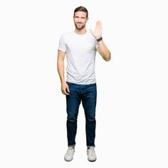 a man standing with his hands in the air and making a stop sign against a white background