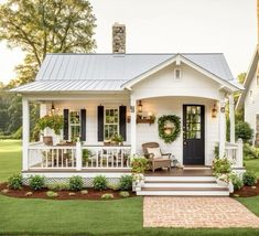 a white house with black shutters on the front porch and steps leading up to it