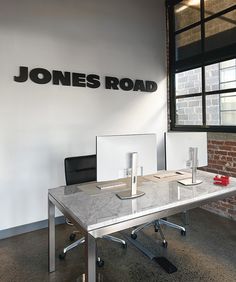 an office with a desk and chairs in front of a sign that reads jones road