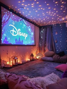 a bedroom with lights on the ceiling and a disney movie screen in the middle of it