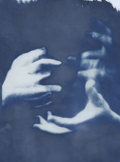 two hands touching each other in front of a blue and white background with brush strokes