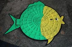 a yellow and green fish on the ground