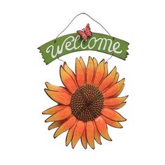 a welcome sign with a large sunflower on the front and green ribbon hanging from it's center