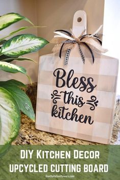 a kitchen sign with the words, diy kitchen decor upcycled cutting board