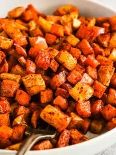 a white bowl filled with cooked cubed potatoes