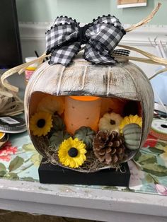 a decorated pumpkin with sunflowers and other decorations