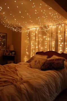 a bed with white lights hanging from the ceiling