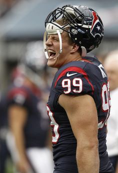 a football player wearing a helmet with his mouth open and tongue out in the air