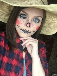 a woman with makeup painted to look like a skeleton wearing a cowboy hat and holding her hand on her chin