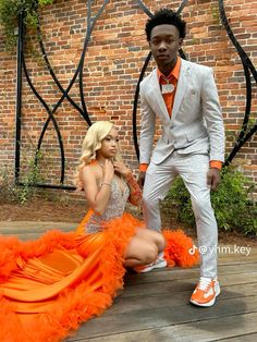 Navy Blue And Orange Prom Couple, Orange Prom Send Off Ideas Decorations, Orange Tuxedo Prom, Orange And Silver Prom Dress, Prom Inspiration Couples, Prom Colors For Couples Black, Prom Dresses Couples, Orange Prom Suit, Orange Prom Couple