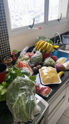 a kitchen counter filled with lots of vegetables