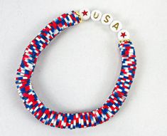 a red, white and blue bracelet with the word usa written on it's side