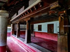 the inside of an old building with red and white paint on the walls, floors and ceiling