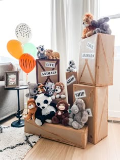 there are many stuffed animals in boxes on the floor next to each other and balloons