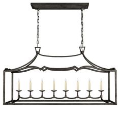 an iron chandelier with candles hanging from the front and back ends, on a white background