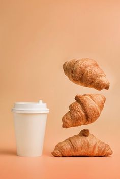 croissants falling into a coffee cup