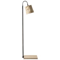 a floor lamp with a white shade on it