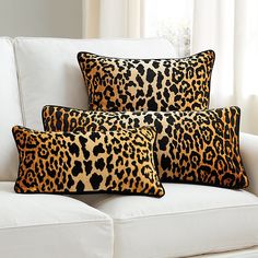 three leopard print pillows on a white couch