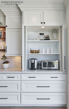 a kitchen with white cabinets and open shelves