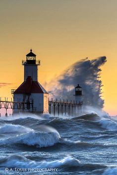 a lighthouse in the ocean with waves crashing around it and a sky filled with clouds