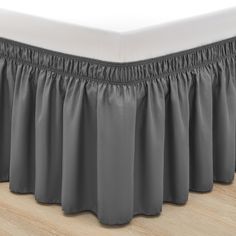 the pleated bed skirt is made with grey fabric