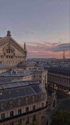 an aerial view of paris at dusk with the eiffel tower in the distance