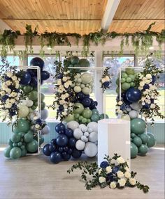 balloons and greenery are arranged on the floor