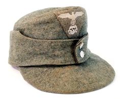 an army hat with a skull and eagle patch on the front, sitting against a white background