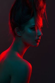 a woman with red light on her face and hair in the shape of a head