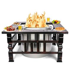 a table with food and drinks on it, including an oval fire pit in the center