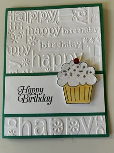 a happy birthday card with a cupcake on the front, and words in white