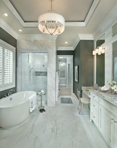 a large bathroom with two sinks and a bathtub next to a walk in shower