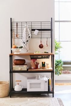 a kitchen shelf with pots, pans and utensils