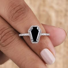 a woman's hand with a black and white diamond ring