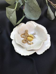 a white flower with two gold rings on it