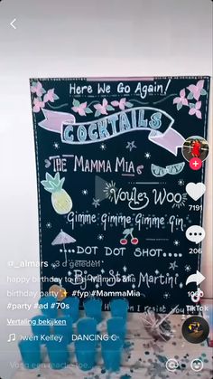 a chalkboard sign with the names of various cocktails and drinks on it, along with other items