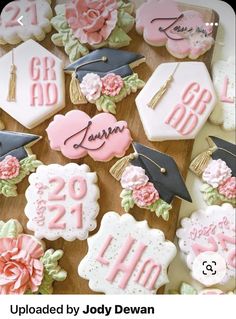 decorated cookies with graduation caps and flowers are on a wooden board that says class of 2013