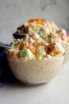 two bowls filled with food sitting on top of a table