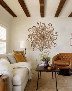 a living room with two couches and a coffee table in front of a wall decoration