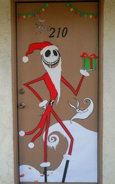 a door decorated with an image of a santa clause holding a present and the number twenty on it