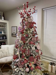 a christmas tree decorated with red, white and silver ornaments