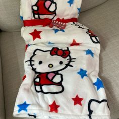 a hello kitty blanket on a couch with red, white and blue stars