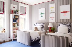 two twin beds in a bedroom with striped walls