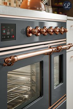 an oven with copper knobs in a kitchen