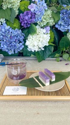 a tray with some purple and white flowers