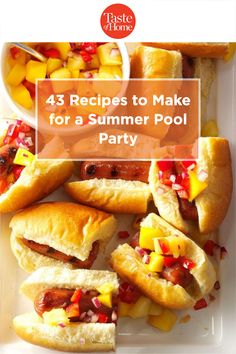 a white plate topped with hot dogs and fruit