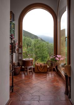 an arched doorway leading to a lush green valley