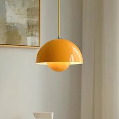 an orange light hanging from a ceiling in a room