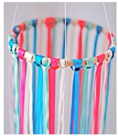 a multicolored wind chime hanging from a string in the shape of a circle