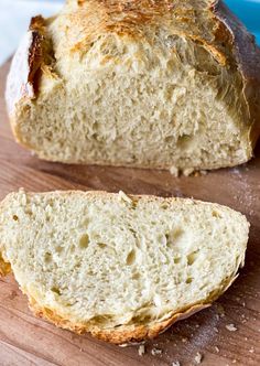 a loaf of bread sitting on top of a wooden cutting board